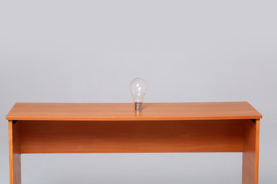 Light bulb standing on desk