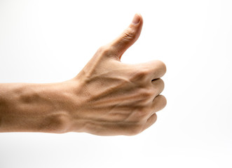 Closeup of male hand showing thumbs up sign against white backgr