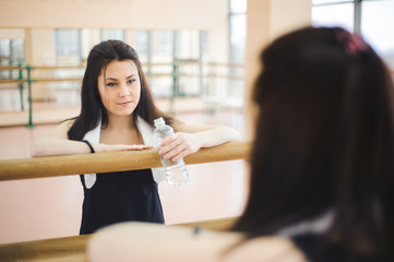 young healthy woman drinking water in fitness