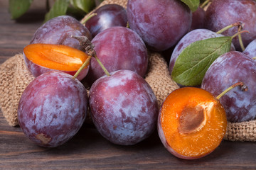 plum on the wooden background with sackcloth