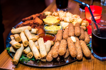 Silver plate full of appetizers finger food starters at party. - obrazy, fototapety, plakaty