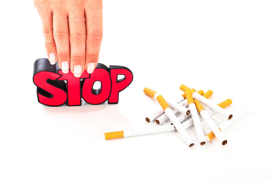 Stop smoking concept, bunch of cigarettes on white background with sign stop