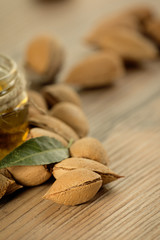 Almond oil and almonds, selective focus