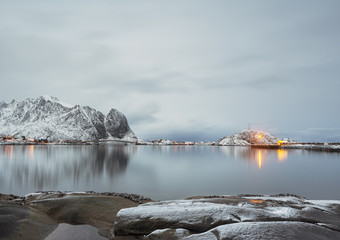 Reine village at dusk with reflections in the water, Lofoten, Norway.