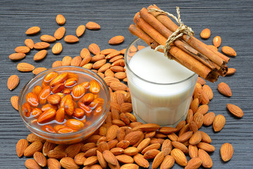Raw almonds soaking in a white bowl of water
