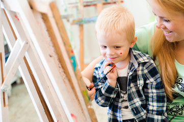 Mother and child draw a picture paints, art lesson