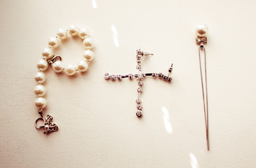 Silver and pearl jewerly lie on the white table