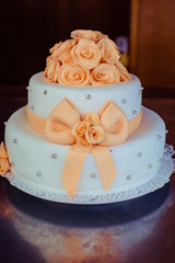 Wedding bouquet decorated with orange roses and silver pearls