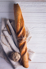 Freshly baked baguette in cloth