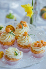 very nice sweet table with yellow macaroons and white cupcakes