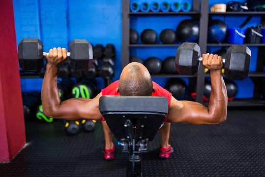 Man With Dumbbells On Weight Bench