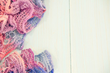 winter woolen scarf on stylized wooden window sill. Winter concept of comfort and relaxation.