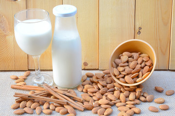 Almond milk with almond on a wooden table
