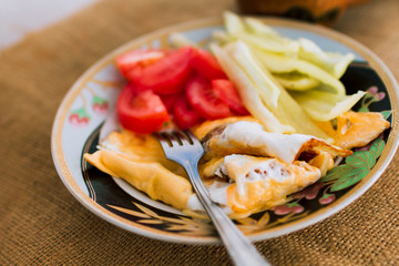 Homemade breakfast of fried eggs and vegetables