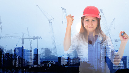 businesswoman with Crane and workers at construction site against blue sky.
