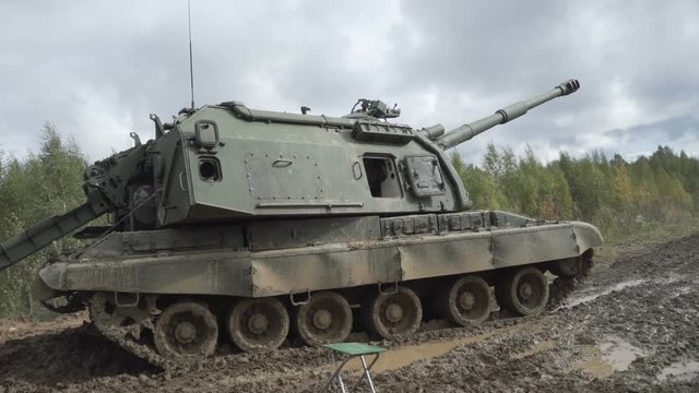 Self-propelled artillery unit on the road in a forest