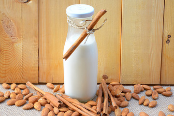 Almond milk with almond on a wooden table
