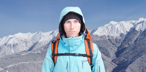 Hiker man in winter mountains.