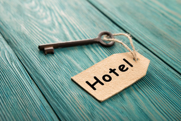 hotel key with tag on the wooden background