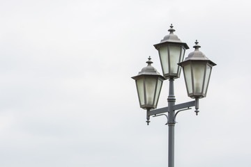 Fototapeta na wymiar Old Street light on sky background