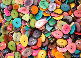 background of colorful buttons made with dried palm seeds for sa