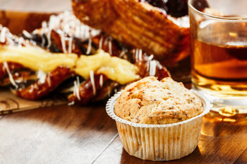 pastries, buns, custard cake, a glass of apple juice on the table. Close-up