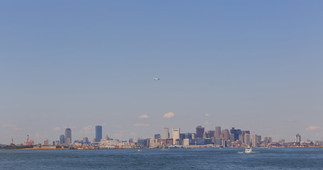 Naklejka premium Plane over the Boston Skyline