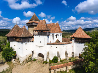 Fototapeta na wymiar Viscri fortified Chruch in the middle of Transylvania, Romania. Aerial view from drone. Important tourist attraction.