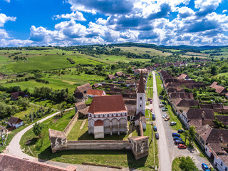 The fortified church Cloasterf. Traditional saxon village in Transylvania, Romania. Aerial view from a drone. HDR image.