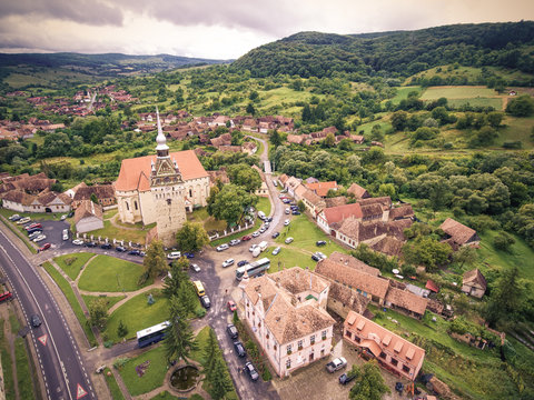 Saschiz saxon village and fortified Church in middle Transylvania, Romania, Eastern Europe. Aerial view from a drone.