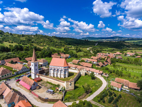 The fortified church Cloasterf. Traditional saxon village in Transylvania, Romania. Aerial view from a drone. HDR image.
