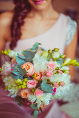 Smiling lady holds pink and green bouquet