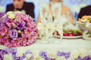 Rich champagne flutes with peach bows and crystals