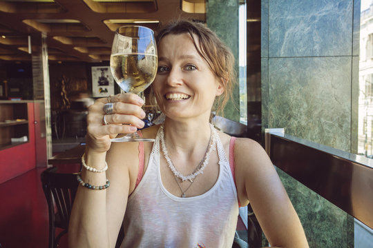 Woman with glass of wine doing heers