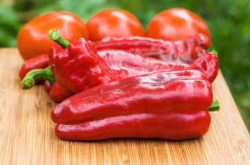 Red fresh pepper fruits on wooden Board
