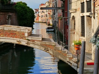 Fototapeta na wymiar Venice step bridge evening reflections