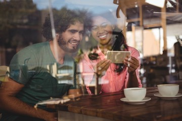 Couple looking at mobile phone