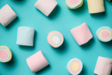 Top view of pastel colored marshmallow on a blue background. Min