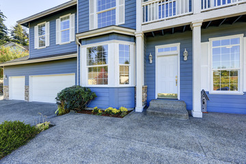Blue house exterior. View of entrance porch with concrete floor