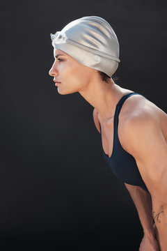 Focused young woman in swimsuit looking away