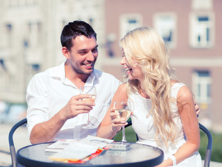 couple drinking wine in cafe