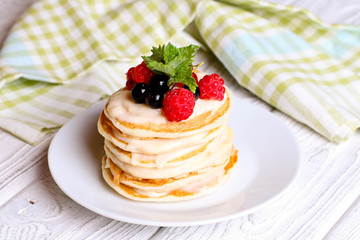Summer cottage cheese pancakes on white plates on a table