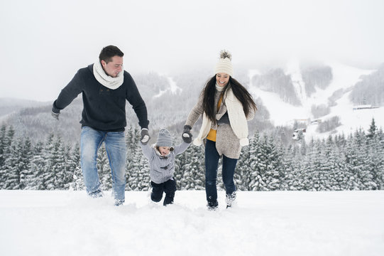 Happy family in winter landscape