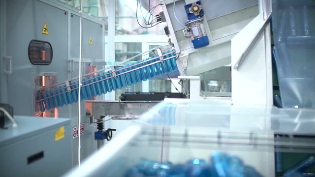 The preform of plastic bottles. Production of plastic packaging. Machine blowing plastic bottles. A lot of blanks for plastic bottles. for packaging production plant