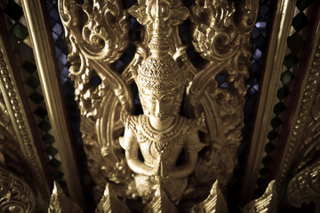 the perforate on the door in public temple in Thailand with dark tone, this picture is generic art...