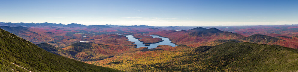 Fototapeta premium Panoramic view of the Adirondack Mountains featuring Lake Placid on a sunny autumn day as seen by looking south west from the summit of Whiteface Mountain in Wilmington, New York