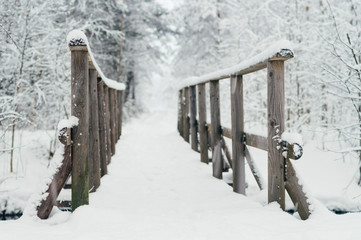 Wooden bridge covered by snow