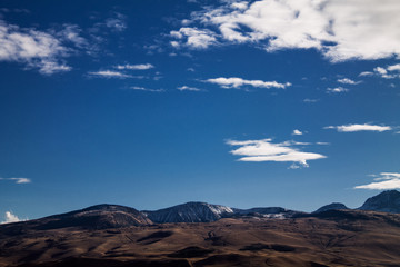 Fototapeta na wymiar mountain and clouds on the blue sky