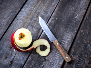 Peeled ripe Apple wooden table
