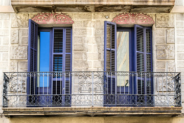Fototapeta na wymiar Beautiful building facade: Old style windows, balcony. Barcelona. Spain.